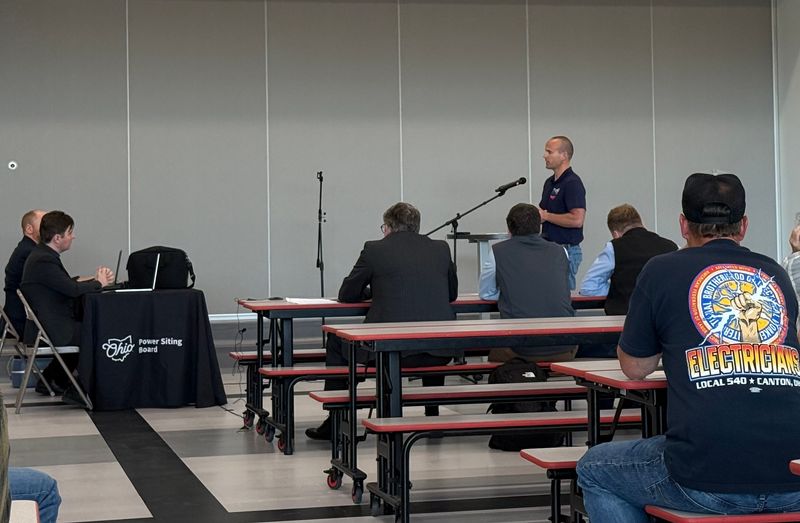 Erik Hann, of International Brotherhood of Electrical Workers Local 540 and the East Central Ohio Building and Construction Trades Council, speaks in support of the Chestnut Run Energy project during an Ohio Power Siting Board hearing at Carrollton Elementary School.