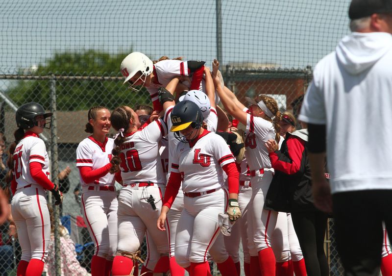 Liberty Union players lift Haedan Brunty into the air following her home run during the Lions' 2-1 victory against Northmor to win a Division V district championship at Pickerington North on May 21, 2026.