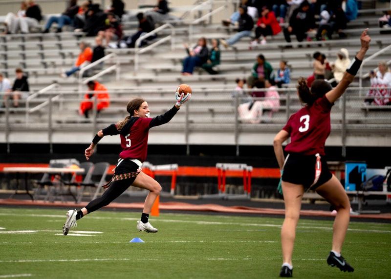 Brooklyn Kaneff runs into the end zone, scoring her first touchdown in the last game of the season against Cornerstone. Teammate Angie Dowell mirrors her movements in celebration. The Wildcats won the game 32-6. The win wasn’t enough to get them into the playoffs this season. The first-year team went up against established teams with more experience, but still held their own with a record of 5-5 and no losses on their home field.
