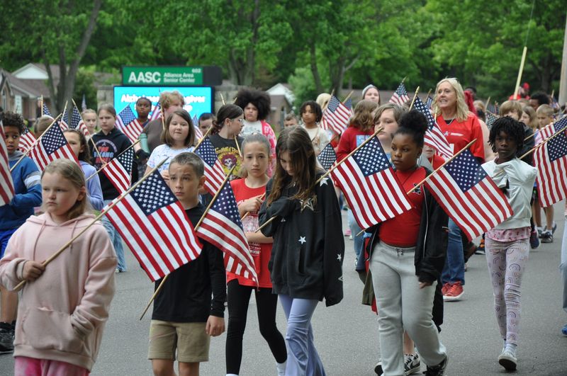 Alliance Intermediate School students and staff members continued a solemn Memorial Day tradition, dating to at least the 1950s, by marching one mile from the school to Alliance City Cemetery, where they honored fallen U.S. military personnel.