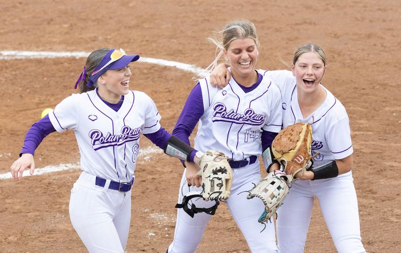Jackson’s Annalise Wilson (left), pitcher Avery Wile, and Remi Grooms celebrate a 1,2,3, fourth inning against Medina in the Division I district final on Friday, May 22, 2026. Bob Rossiter / Special To The Canton Repository