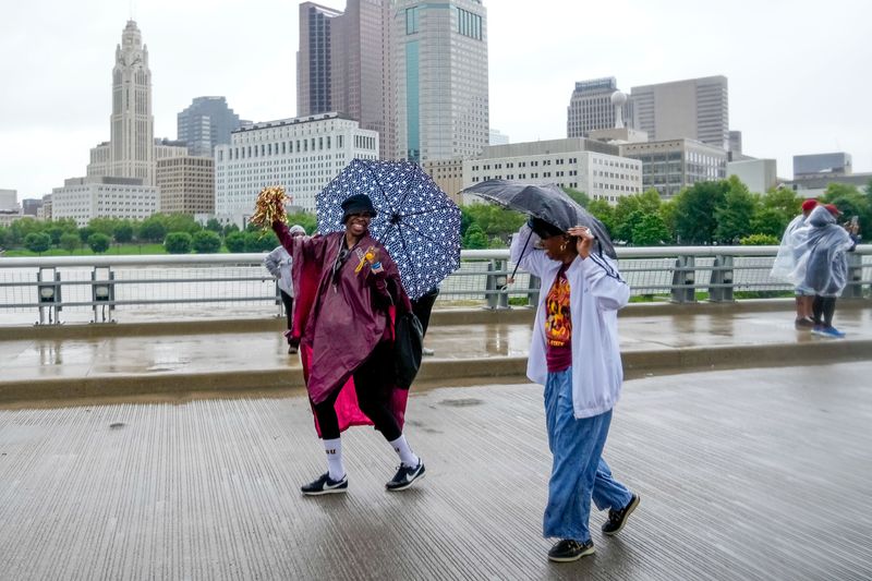 Woman dance in the rain during the Ohio Black Expo: Riverfront Culture Fest on the West Rich Street bridge on Saturday, May 23, 2026 in Columbus, Ohio.