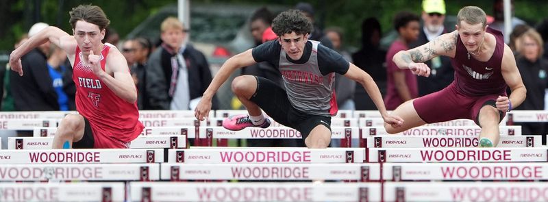Field’s Logan Border, Northwest’s Logan Allman and Woodridge’s Connor Hons compete in the Boys 110m Hurdles at the OHSAA Division III District Track and Field meet at Woodridge High School in Peninsula, Ohio on May 23, 2026.