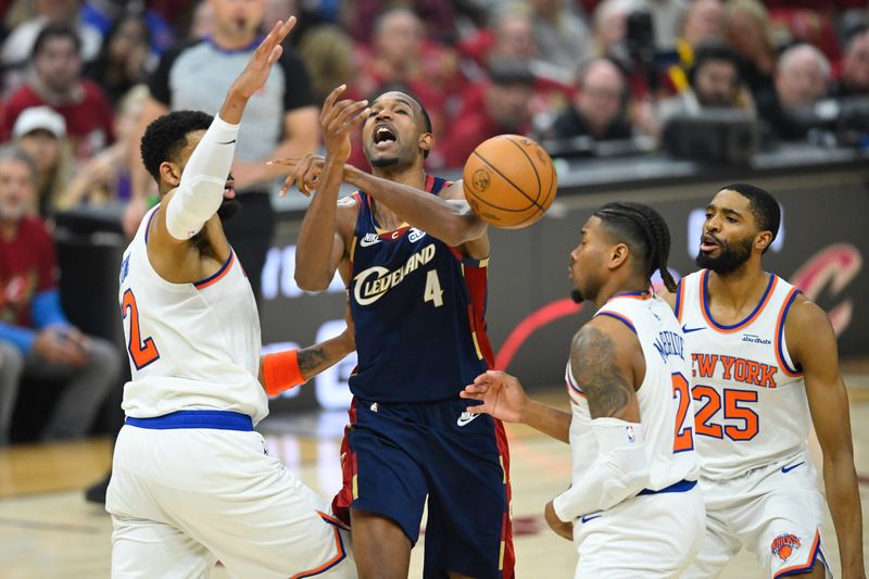 May 23, 2026; Cleveland, Ohio, USA; Cleveland Cavaliers forward Evan Mobley (4) loses the ball while defended by New York Knicks center Karl-Anthony Towns (32) in the first quarter during game three of the eastern conference finals for the 2026 NBA playoffs at Rocket Arena. Mandatory Credit: David Richard-Imagn Images