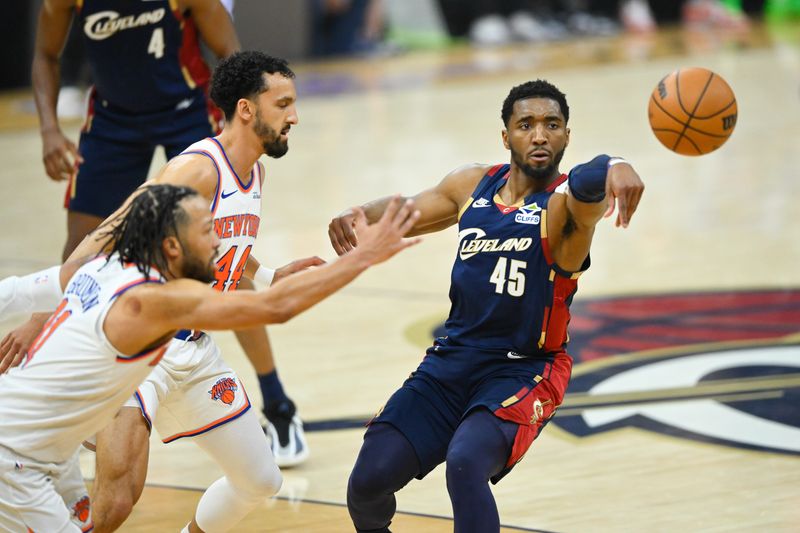 May 23, 2026; Cleveland, Ohio, USA; Cleveland Cavaliers guard Donovan Mitchell (45) passes while defended by New York Knicks guard Jalen Brunson (11) in the first quarter during game three of the eastern conference finals for the 2026 NBA playoffs at Rocket Arena. Mandatory Credit: David Richard-Imagn Images