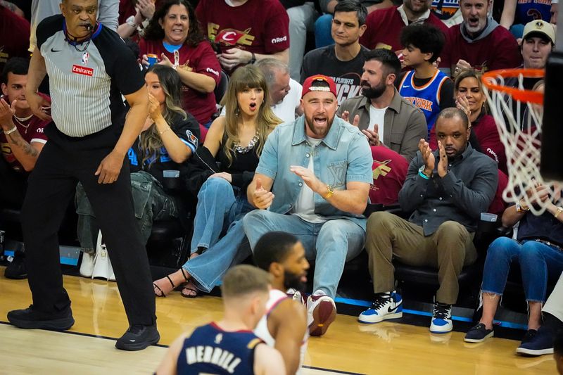 Taylor Swift and Travis Kelce cheer during the second quarter of game 3 of the NBA Eastern Conference Finals between the Cavs and Knicks, May 23, 2026, in Cleveland.