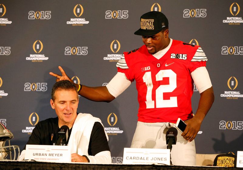 Jan 12, 2015; Arlington, TX, USA; Ohio State Buckeyes quarterback Cardale Jones (12) jokes around with Ohio State Buckeyes head coach Urban Meyer during a press conference after beating the Oregon Ducks in the 2015 CFP National Championship Game at AT&T Stadium. Mandatory Credit: Tim Heitman-USA TODAY Sports