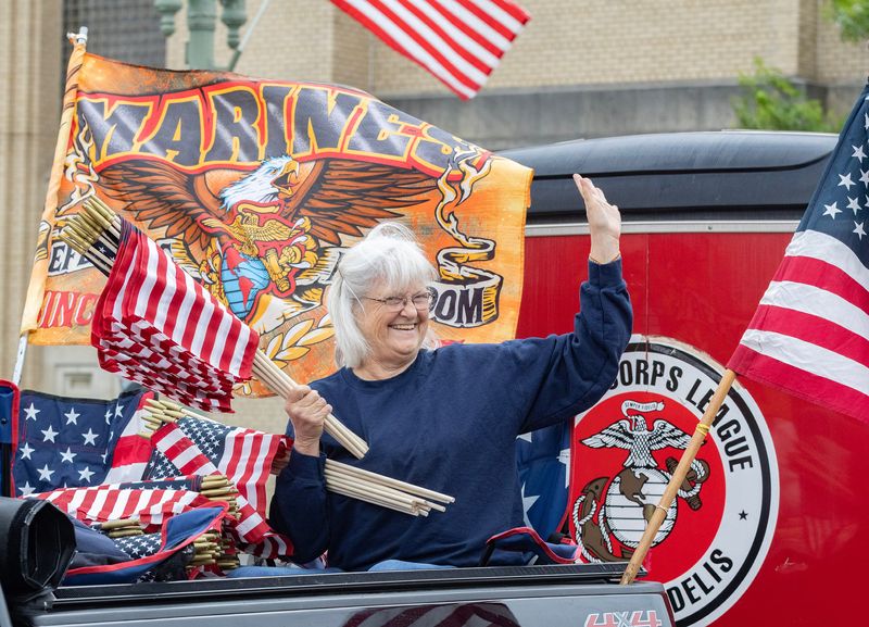 A Canton Memorial Day parade participant waves during the event. May 25, 2026