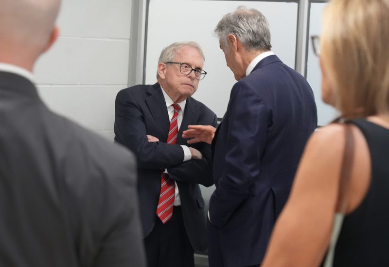 Ohio Gov. Mike DeWine talks with Dr. Mehmet Oz, the administrator of the Centers for Medicare and Medicaid Services, during an event in Columbus on May 26.