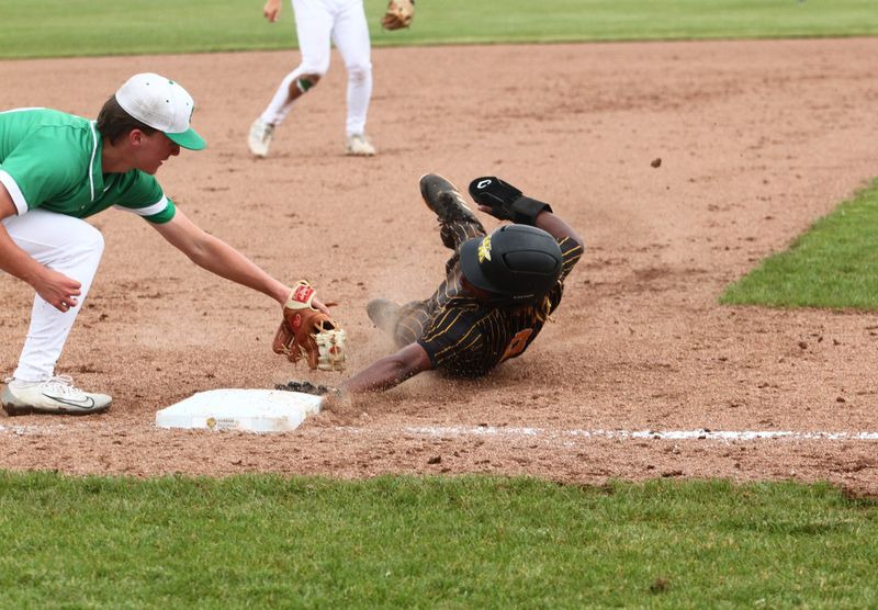 Watkins Memorial's Cam Burt slides safely into third base during the Warriors' 6-5 eight-inning loss to visiting Dublin Scioto in a Division II district semifinal on May 26, 2026.