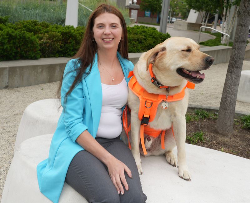 Abigail Spraggins, founder and CEO at Abby's Helping Hands, Hopeful Hearts, is one of this year's Twenty under 40! honorees. She is shown with service dog Georgie.