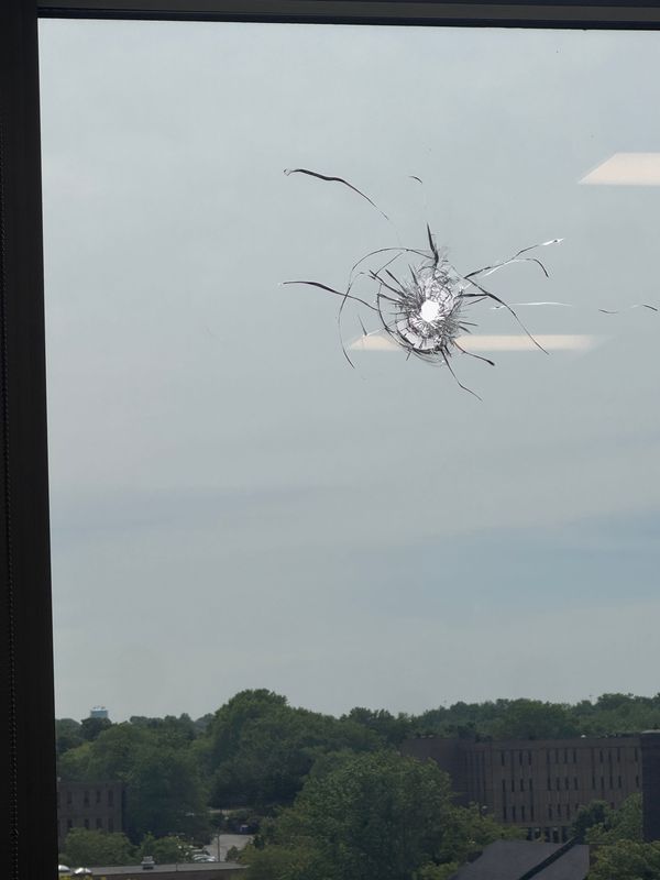 A bullet hole is seen in Akron Beacon Journal Executive Editor Cheryl Powell's office window in downtown Akron.