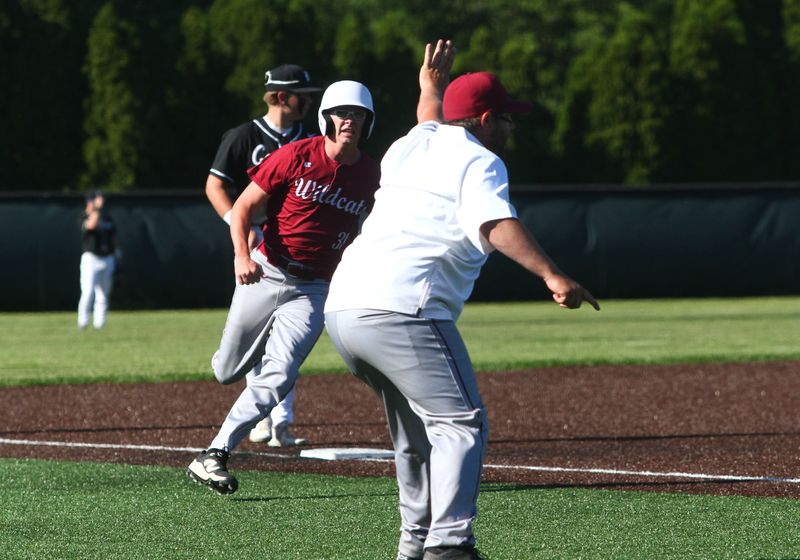 Newark's Trenton Wilson sees the stop sign from coach Michael Wheeler as he rounds third base during the Wildcats' 11-1 victory at Dublin Coffman to win a Division I district championship on May 28, 2026.
