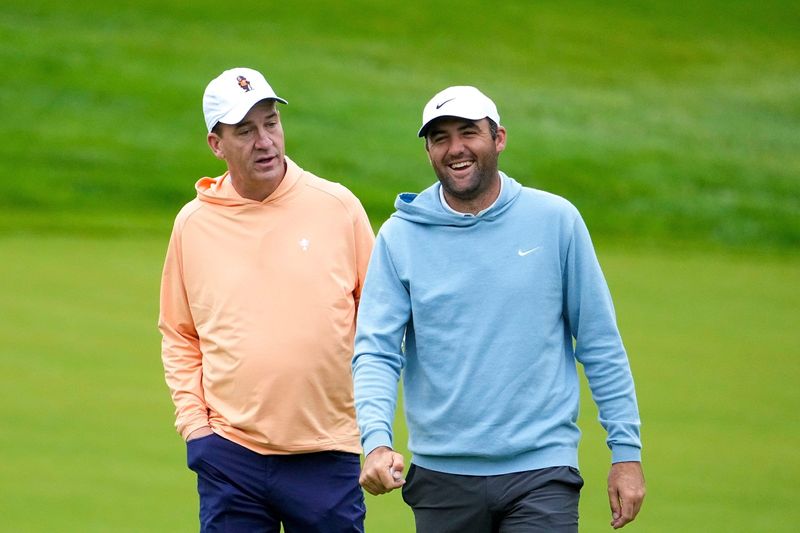 Peyton Manning makes Scottie Scheffler laugh as they walk to hole No. 4 during the Workday Golden Bear Pro-Am at the Muirfield Village Golf Club on May 28.