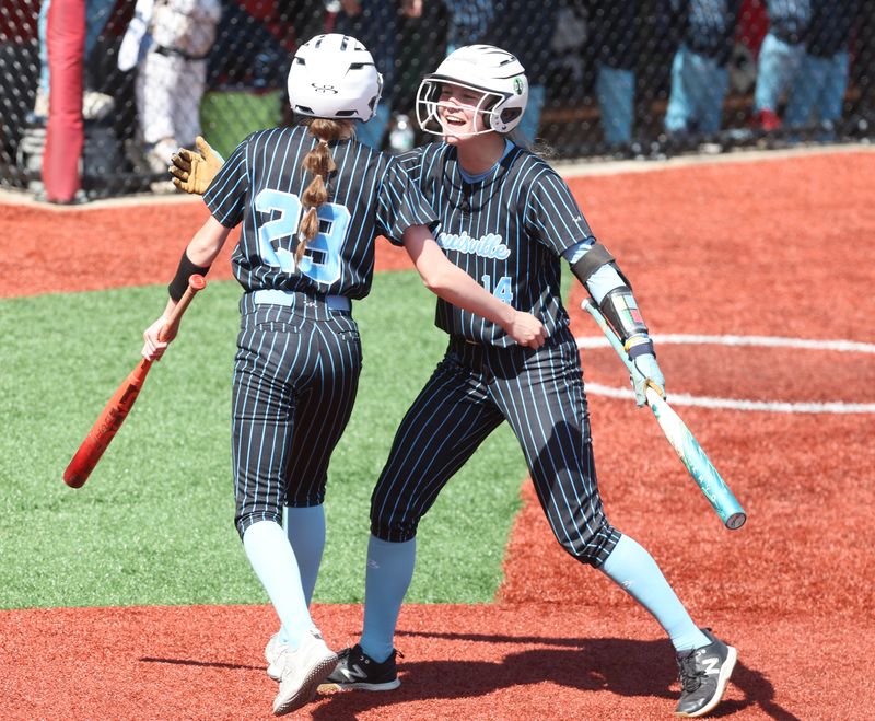 Louisville’s Kaden Weaver (29) and Addyson Upperman (14) celebrate Upperman’s fourth inning run against Archbishop Hoban in an OHSAA Division III regional final, Friday, May 29, 2026.
