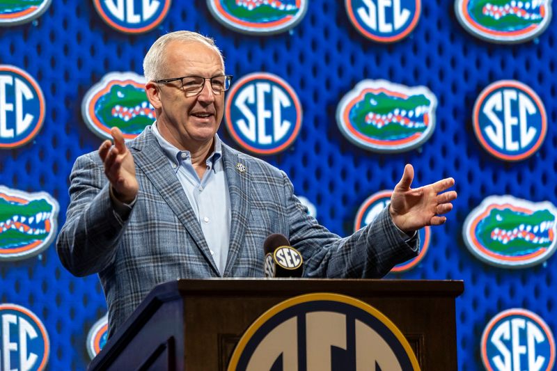 Oct 15, 2025; Birmingham, AL, USA; SEC commissioner Greg Sankey introduces Florida Gators head coach Todd Golden during SEC Media Days at Grand Bohemian Hotel. Mandatory Credit: Vasha Hunt-Imagn Images