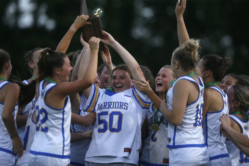 Mariemont players celebrate their regional championship after defeating Indian Hill 11-9 in the OHSAA Division II girls lacrosse regional finals May 29, 2026, at Mariemont's Kusel Stadium.