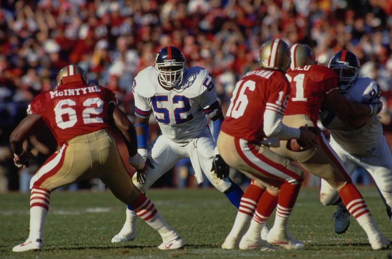 Pepper Johnson #52, Right Inside Linebacker for the New York Giants keeps his eyes on #16 Joe Montana, Quarterback for the San Francisco 49ers at the snap on the line of scrimmage during the National Football Conference Championship game against the San Francisco 49ers on 20th January 1991 at Candlestick Park, San Francisco, California, United States. The Giants won the game 15 - 13. (Photo by Otto Greule Jr/Allsport/Getty Images)"n