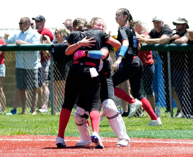 Licking Valley pitcher Emory Whisner, left, hugs catcher Chloe Coooperrider after securing the final out of a 1-0 win against John Glenn in a Division IV regional final on Saturday, May 30, 2026, at the Philo Athletic Complex in Duncan Falls, Ohio. Valley, now 26-0, advanced to the state tournament as Whisner tossed a three-hitter and escaped a two-on, none-out jam in the seventh to secure the victory.