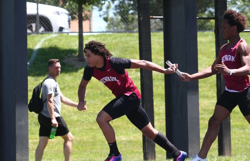 Newark's Camden Booker takes the baton from Jacob Buell for the second leg of the 800-meter relay during the Division I super regional championships at Pickerington North on May 30, 2026.
