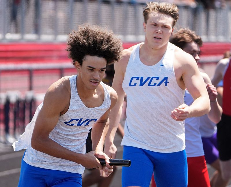 CVCA’s Eli Cherry takes the baton from Tommy Kopec in the boys 400-meter relay at the Division III regional track and field meet May 30, 2026, in Austintown.