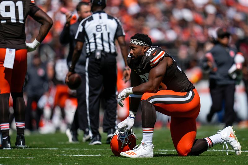 Cleveland Browns defensive end Myles Garrett (95) takes a knee as Cincinnati Bengals guard Lucas Patrick (62) is tended to with an injury in the second quarter of the NFL Week 1 game between the Cleveland Browns and the Cincinnati Bengals at Huntington Bank Field in Cleveland on Sunday, Sept. 7, 2025.