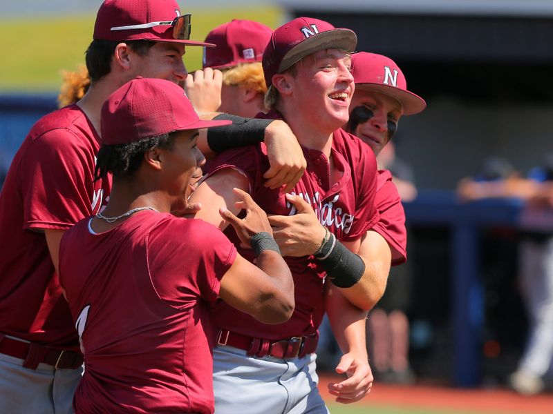 Newark players mob Brody Randall following the Wildcats' 1-0 victory against Olentangy Liberty in a Division I regional semifinal at Beavers Field on June 2, 2026.