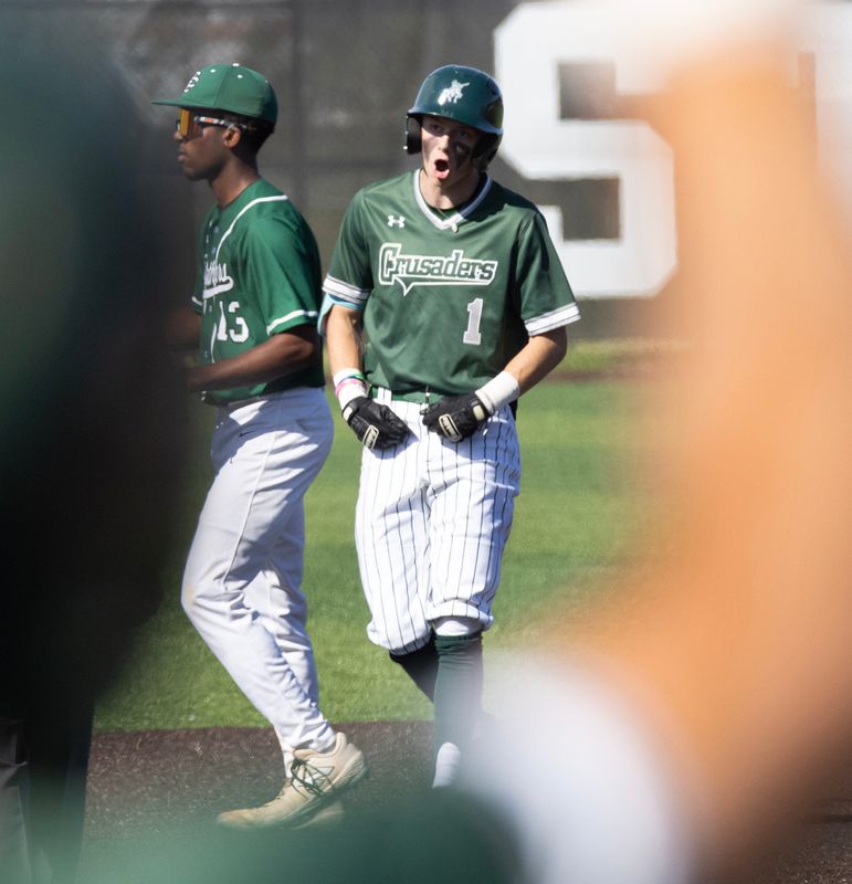 Central Catholic’s Casey Schoenfeld celebrates his double against Elyria Catholic on Tuesday.
