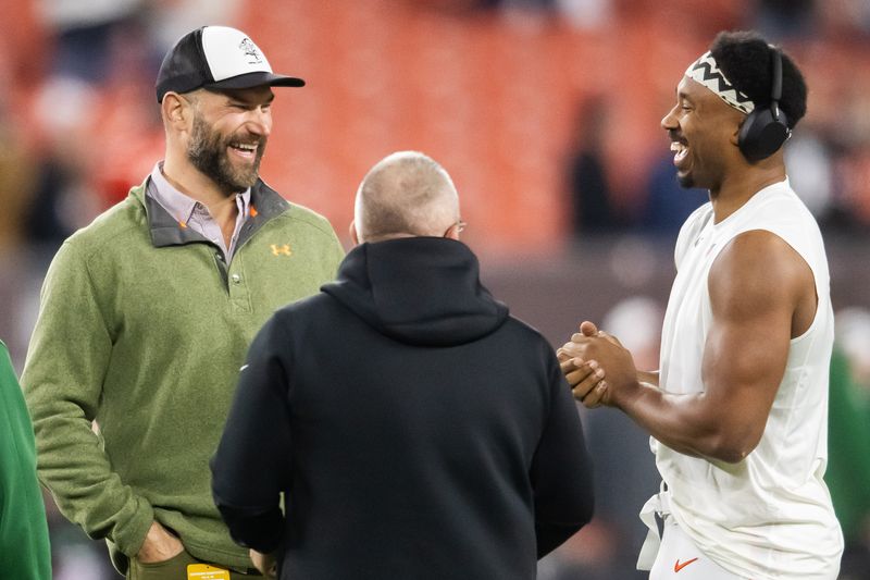 Dec 28, 2023; Cleveland, Ohio, USA; Former Cleveland Browns player Joe Thomas, left, talks with defensive end Myles Garrett, right, before the game between the Browns and the New York Jets at Cleveland Browns Stadium. Mandatory Credit: Ken Blaze-USA TODAY Sports