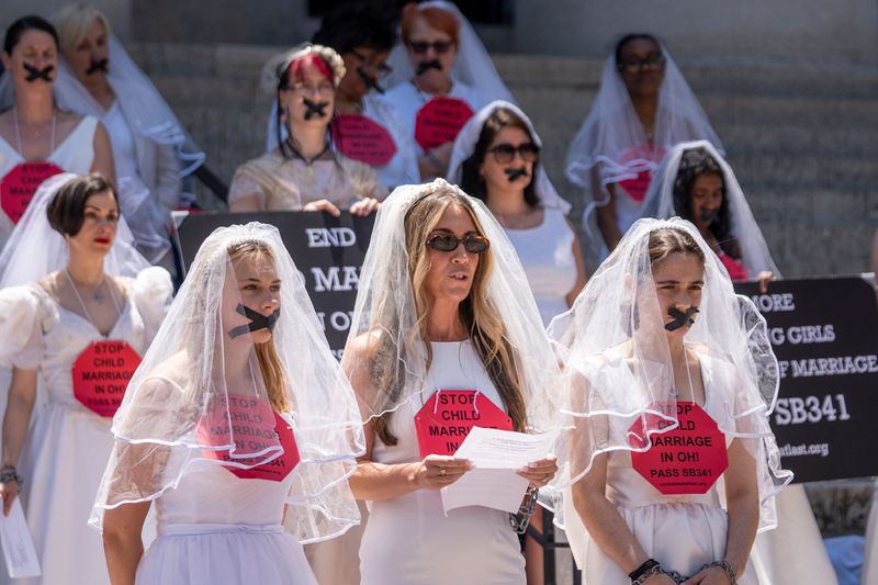 Stephanie Lowry, of Chagrin Falls, with her daughter on the right and her niece on the left talks about her forced marriage at the age of 16, during a protest at the Ohio Statehouse. Ohio lawmakers stalled a bill to eliminate a loophole in state law that allows 17-year-olds to marry. The bill calls for raising the marriage age to 18 and older.
