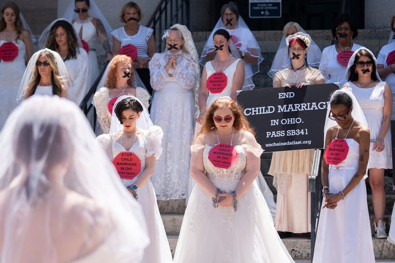 Advocates and survivors with Unchained At Last, a national organization that seeks to end child marriage and forced marriage, protests at the Ohio Statehouse. Ohio lawmakers stalled a bill to eliminate a loophole in state law that allows 17-year-olds to marry. The bill calls for raising the marriage age to 18 and older.