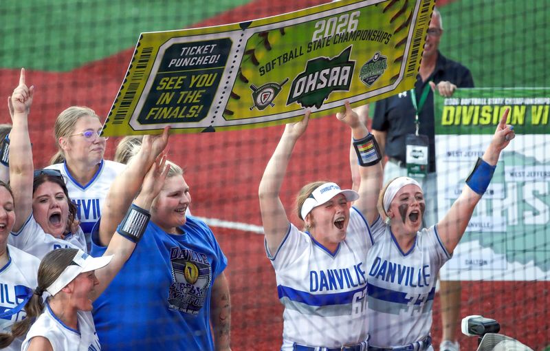Danville shortstop Dalayna Parker (67) and pitcher Addy Bocock (33) hold up their ticket to the state championship game after beating Dalton in a Division VI state semifinal June 3 in Akron.