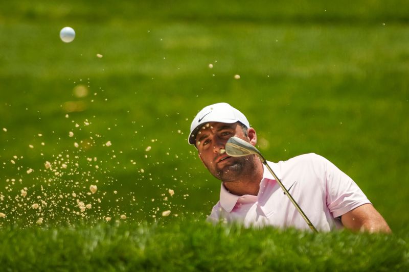 Scottie Scheffler hits out of a bunker on the fourth hole during the first round of the Memorial Tournament at Muirfield Village Golf Club on June 4, 2026.