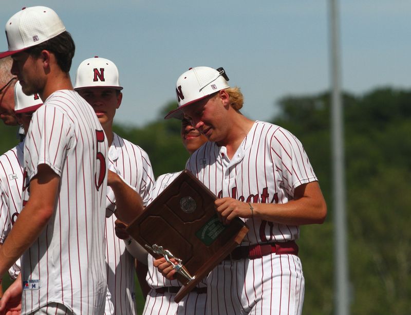 Newark's Moses Crane holds the runner-up trophy following the Wildcats' 12-4 loss to Olentangy Orange in a Division I regional final at Beavers Field on June 4, 2026.