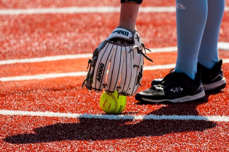 Louisville starting pitcher Katelynn Miller (16) picks up the softball to start her half of the first inning during an OHSAA DIII state semifinal softball game against Madison, June 5, 2026, at Firestone Stadium in Akron, Ohio.