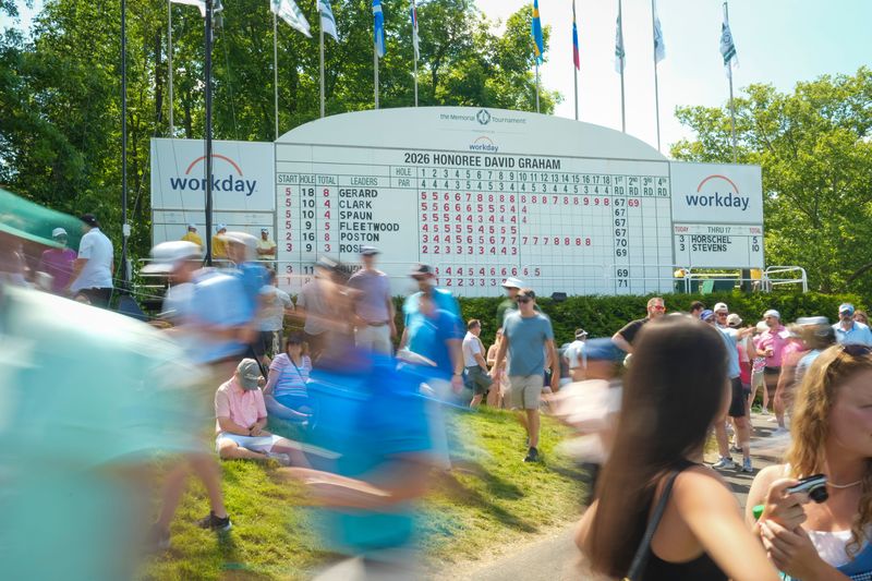 Patrons walk past the scoreboard during the second round of the Memorial Tournament at Muirfield Village Golf Club on June 5, 2026.