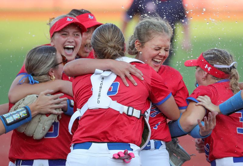 Licking Valley pitcher Emory Whisner is mobbed by teammates after beating Bryan 2-1 on June 5.