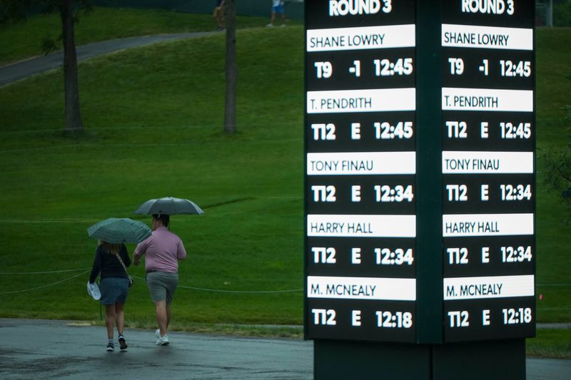 Patrons take cover during a weather delay during the third round of the Memorial Tournament at Muirfield Village Golf Club on June 6, 2026. Lightning and rain stopped play.