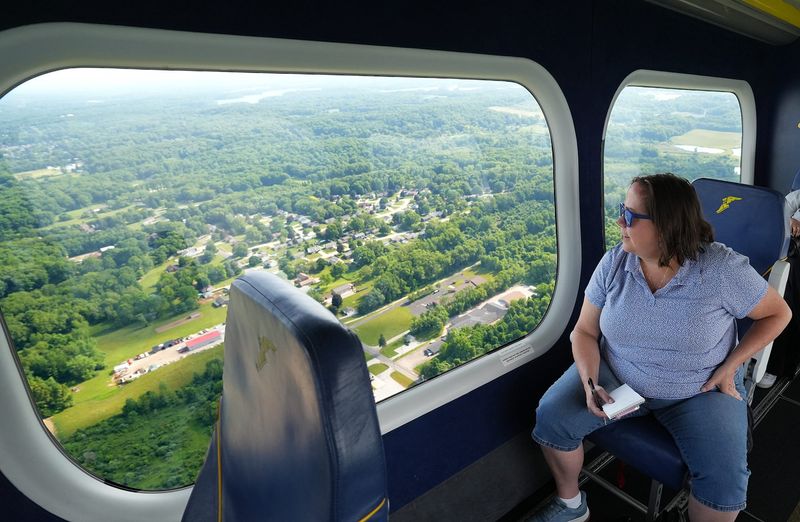 Akron Beacon Journal reporter Stephanie Warsmith takes in the view from Goodyear's Wingfoot One as it and Wingfoot Two fly over Akron's neighborhoods in honor of Blimp Day on June 6, 2026.
