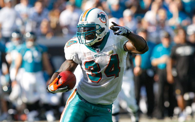 December 13, 2009; Jacksonville FL, USA; Miami Dolphins running back Ricky Williams (34) runs with the ball during the second half against the Jacksonville Jaguars at Jacksonville Municipal Stadium. Miami Dolphins beat Jacksonville Jaguars 14-10. Mandatory Credit: Kim Klement-USA TODAY Sports