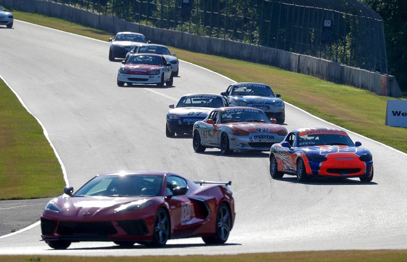 The Chevrolet Corvette pace caer leads a pack of Mazda Miata class cars warm up their tires before racing action at the WeatherTech Chicago Region SCCA June Sprints, Sunday, June 7, 2026, at Elkhart Lake, Wis., Road America.