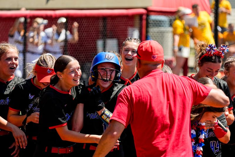 Licking Valley’s Alexa Gilliam, center, makes her way to home plate after a homer during an OHSAA DIV state final softball game against Kenton Ridge, June 7, 2026, at Firestone Stadium in Akron, Ohio.
