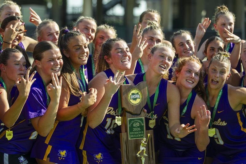 DeSales players celebrate their third consecutive Division II state championship after defeating Bay Village Bay 21-9 on June 7 at Historic Crew Stadium.