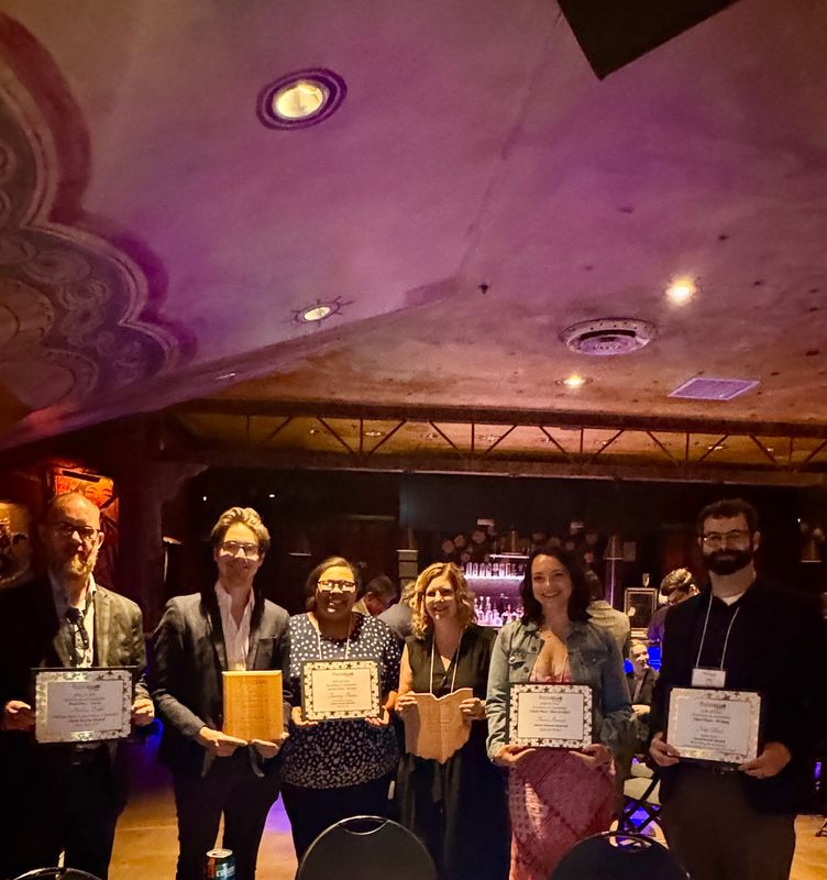 Akron Beacon Journal staff members, from left, Andrew Dolph, Bryce Buyakie, Tawney Beans, Cheryl Powell, Theresa Bennett and Nate Ulrich show off some of their winnings at the All-Ohio Excellence in Journalism awards dinner June 5, 2026, in Cleveland.