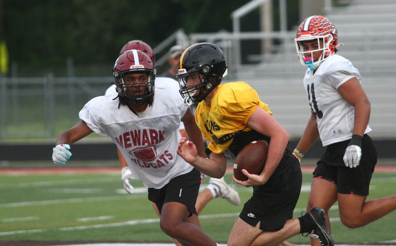 Watkins Memorial's Drew Samsal breaks outside with Newark's Alex Irvin-Royster in pursuit during Licking County All-Star practice on June 8.