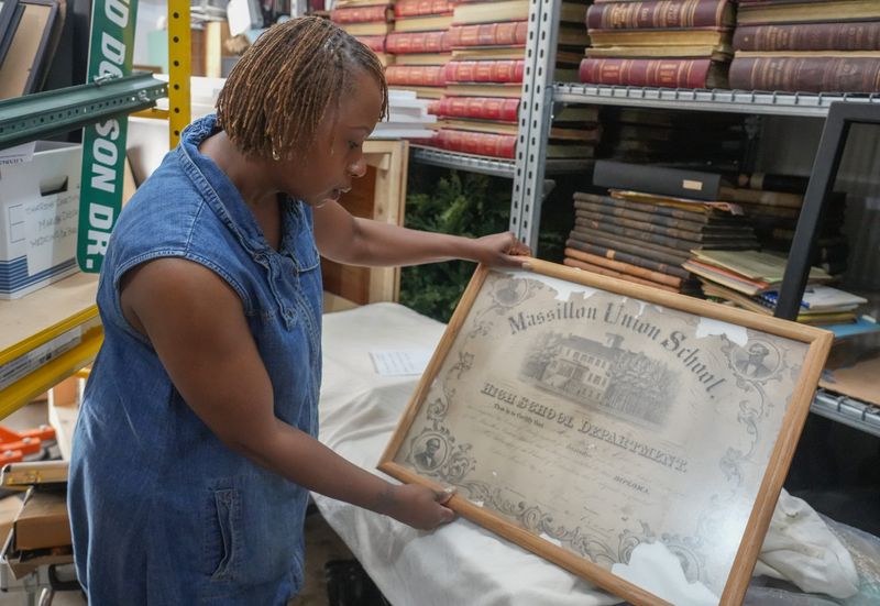Tameka Ellington shows an 1872 diploma from Massillon Union School, which later became Washington High School. It will be featured in the “A Legacy Revived: Exploring Stark County's Rich Black History" exhibition opening June 19 at the McKinley Presidential Library & Museum.