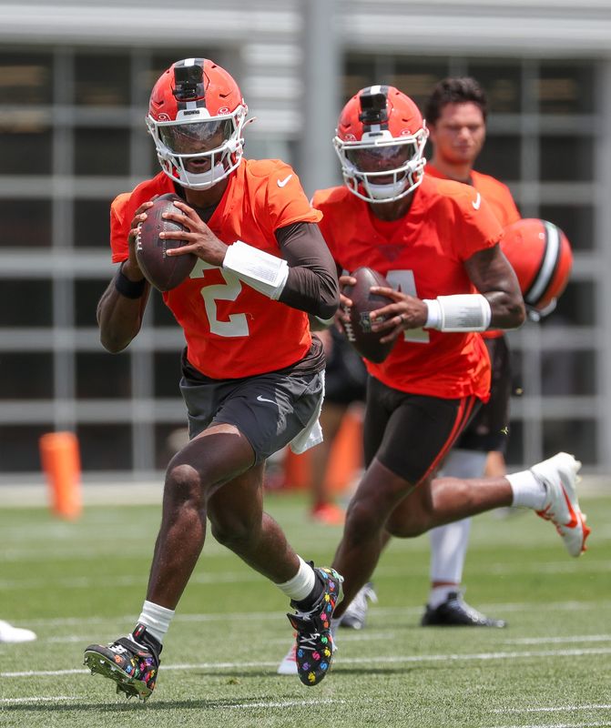 Cleveland Browns quarterback Shedeur Sanders, left, runs drills alongside Deshaun Watson, rear, during the second day of the team’s mandatory minicamp at CrossCountry Mortgage Campus, June 10, 2026, in Berea, Ohio.