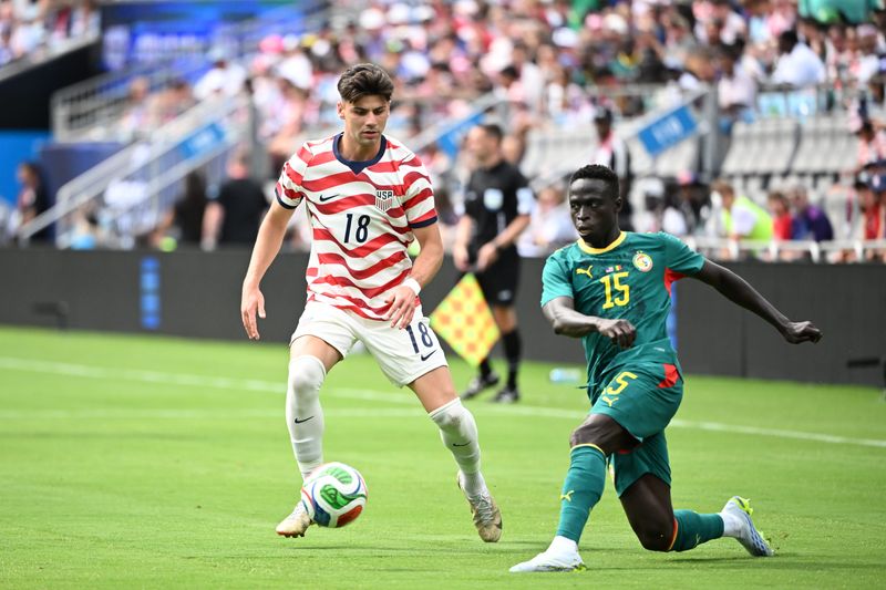 United States defender Max Arfsten (18) tries to take the ball from Senegal midfielder Krepin Diatta (15) in the second half of a May 31 friendly.