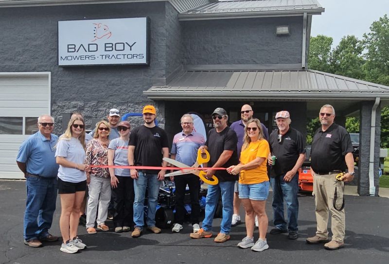 Jack Hutchinson is seen here holding giant scissors as he cuts the ribbon at the Chillicothe location of Jack's Equipment Co. He is seen here on June 12, 2026, surrounded by family, friends, and members of the Chillicothe Ross Chamber of Commerce.