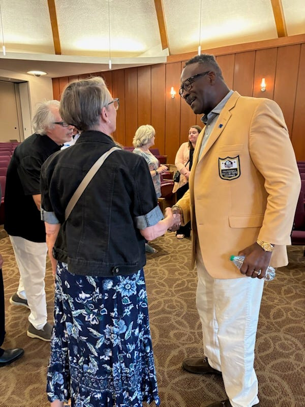 Pro Football Hall of Famer Andre Tippett greets an audience member at Beit Ha'am in Canton following his talk about his conversion to Judaism more than 30 years ago.